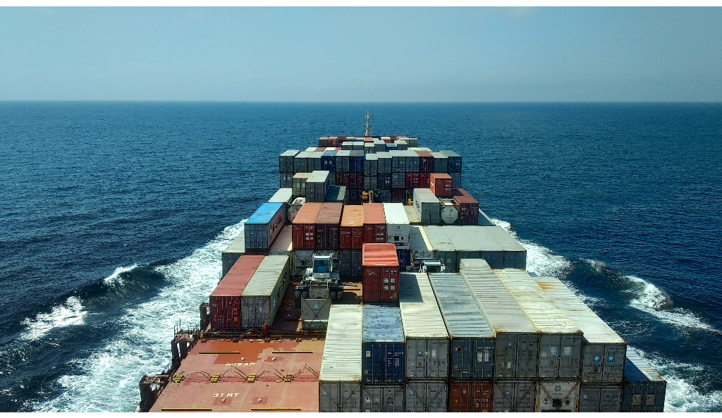 red and white cargo ship on sea during daytime